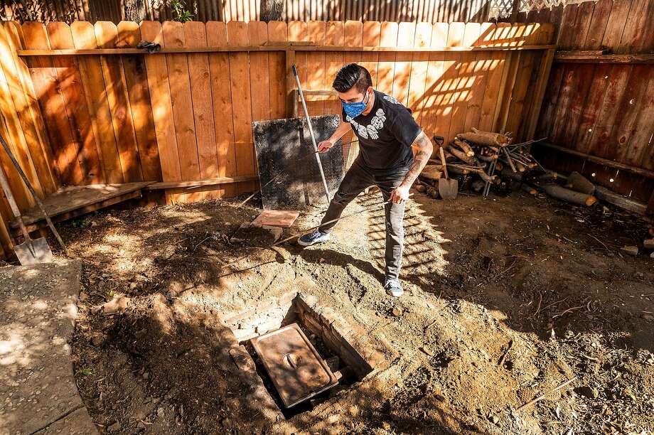 Arcadio Cach removes cochinita pibil from an underground oven for pop-up La Casita Yuca in Richmond. Photo: Noah Berger / Special To The Chronicle