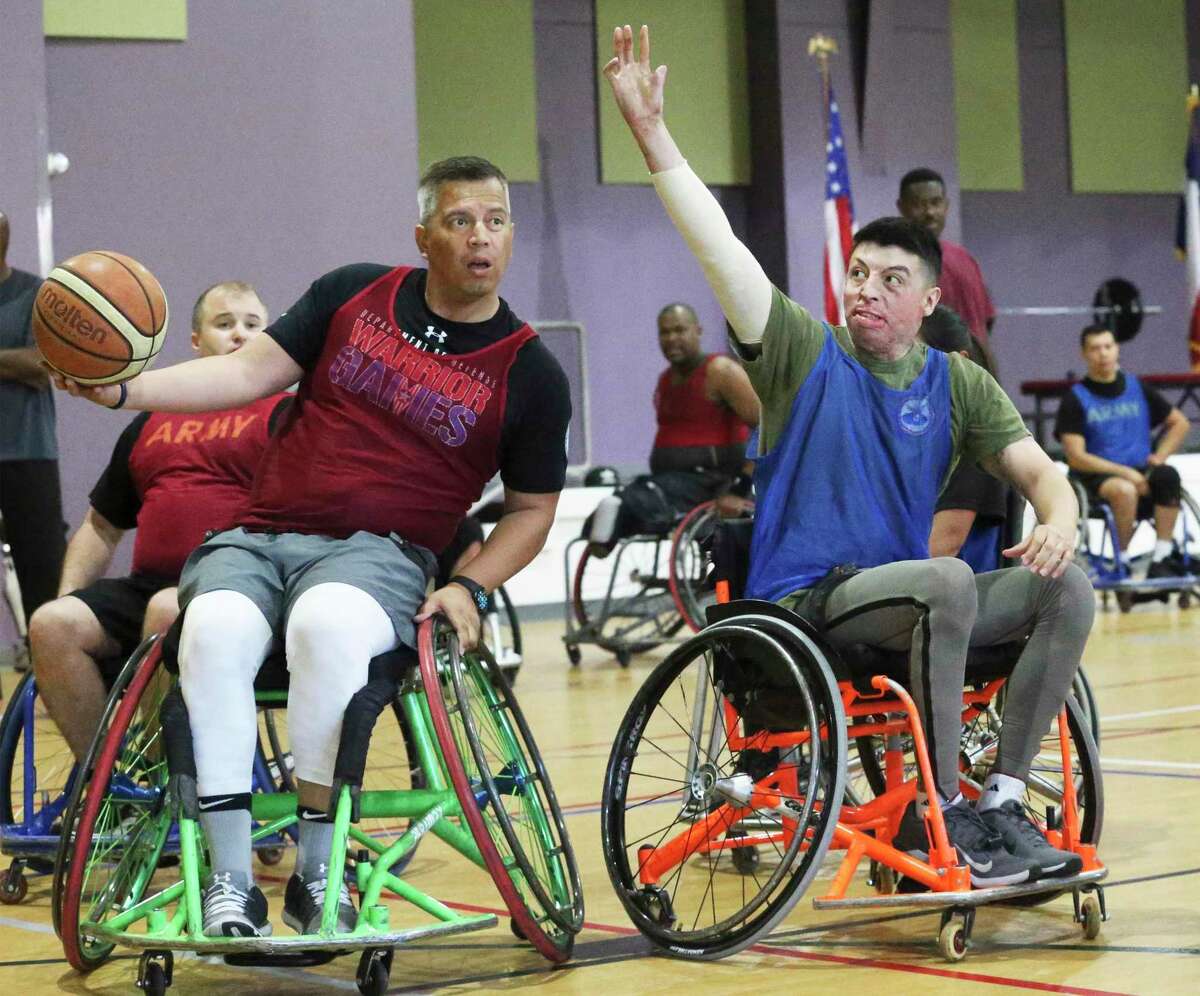 Retired Army Staff Sgt. Armando Gonzales has to pass while defended by Blake DeLeon of the U.S. Marines as San Antonio military and 2019 Warrior Games athletes demonstrate adaptive techniques at the Morgan's Wonderland Event Center on July 10, 2019.