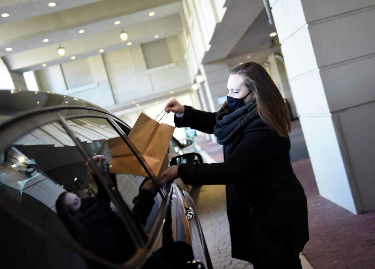 Laura McLoughlin hands off a meals in mid-March 2021 to active and furloughed employees at the Greenwich Hyatt Regency hotel, where she is director of revenue management. ADP reported a spike nationally in leisure and hospitality employment in March, giving the sector hopes for a surge in consumer confidence.