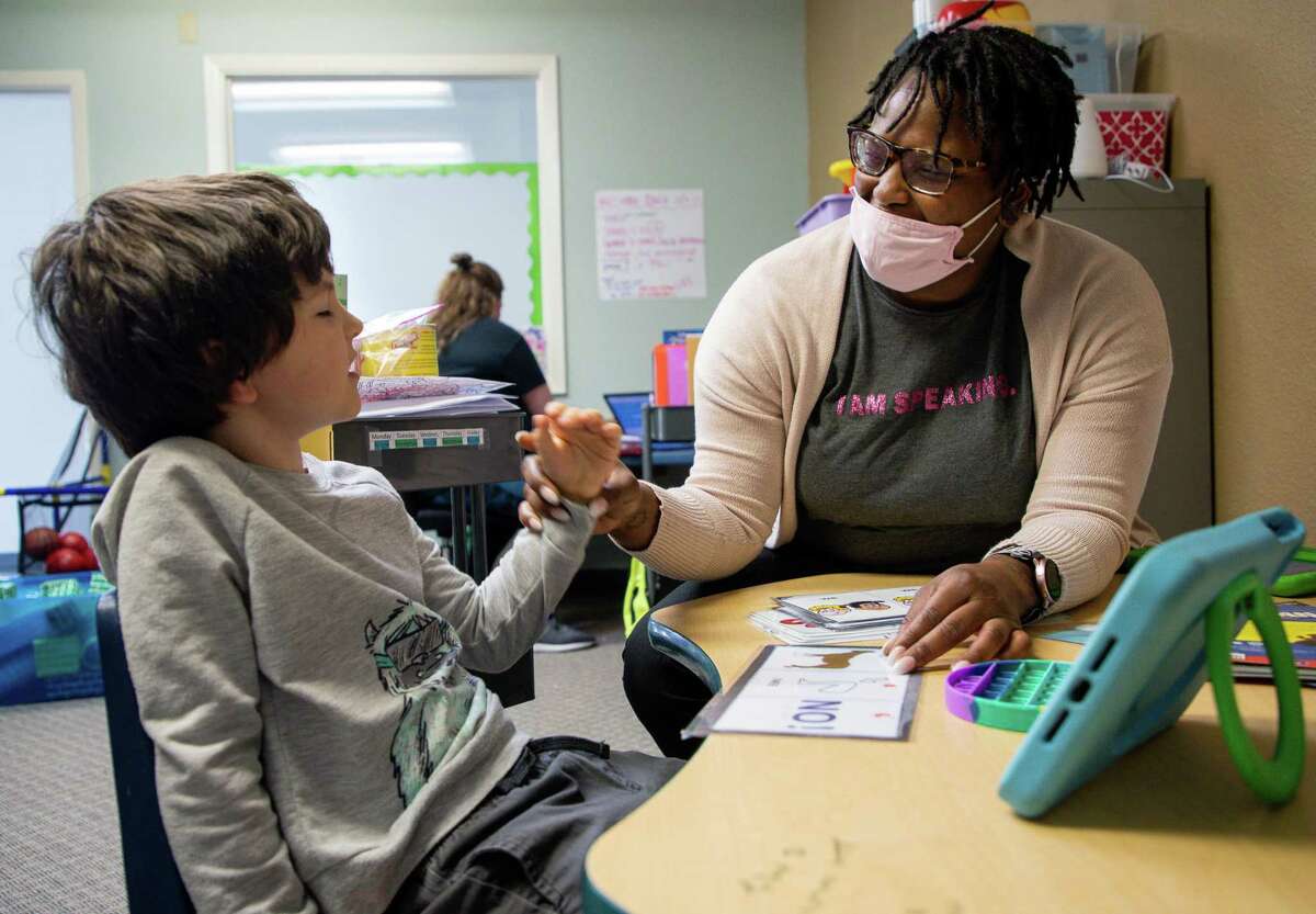 Registered behavior technician Tamara Harbert works with Ben Neel to pronounce words at Texas Autism Academy in The Woodlands. Texas Autism Academy is a nonprofit private school with a 7:2 student-teacher ratio.