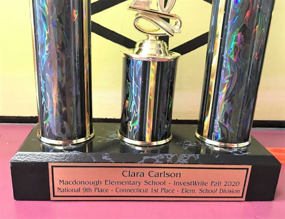 Nine-year-old fourth-grader Clara Carlson won the Connecticut division of the SIFMA Foundation’s fall 2020 National InvestWrite Competition. She was given $200 in an AmEx gift check and this trophy.