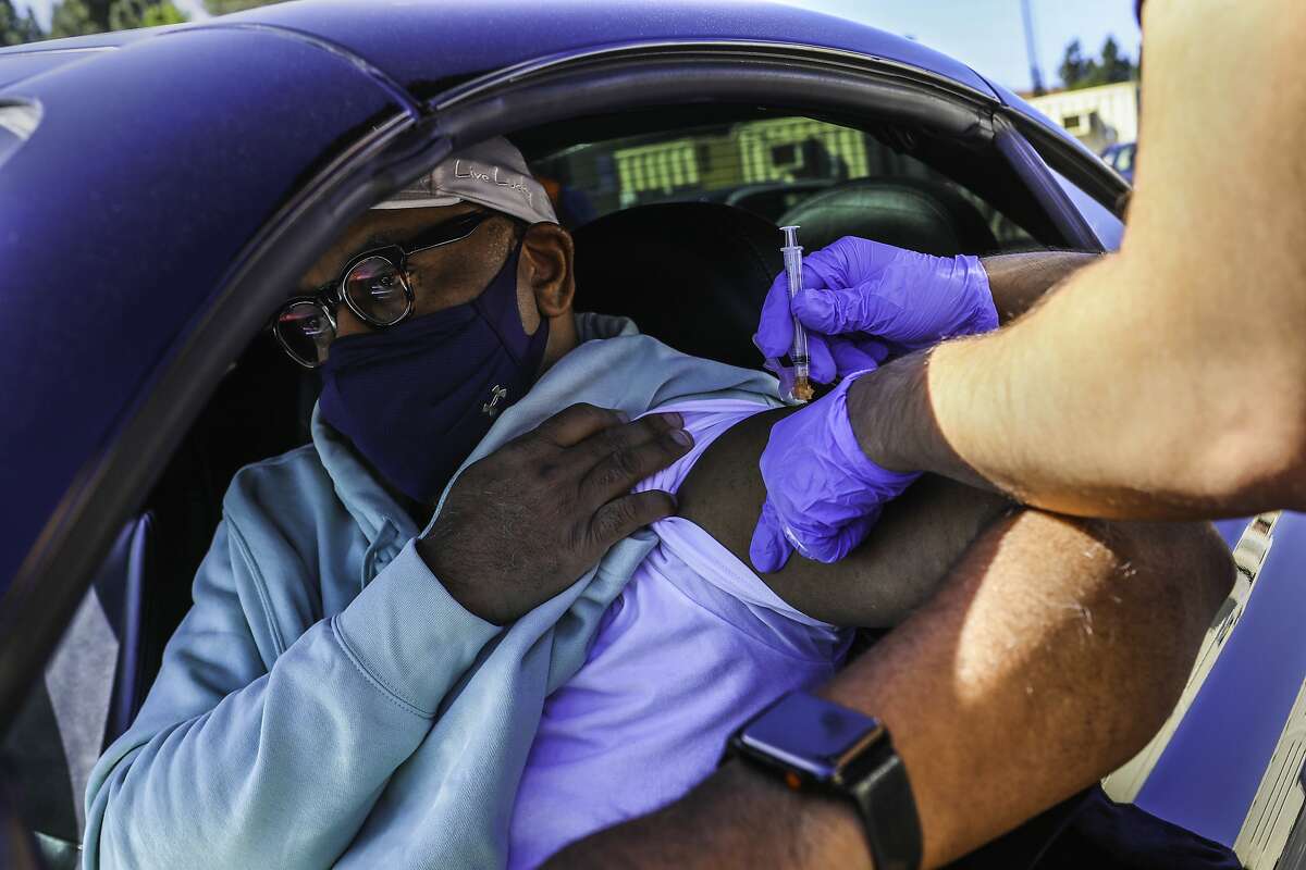 Derrick Sheppard, 53, of Danville, receives the Johnson and Johnson vaccine at the new drive-through COVID-19 vaccination site at Hurricane Harbor Concord on Wednesday, March 31, 2021, in Concord, Calif. "I want to protect, of course, myself and my family, but also my community and some of the older folks in my family as well. I'm very mindful of that," Sheppard said.