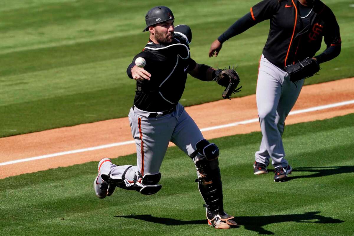 Giants catcher Curt Casali throws out the Angels' Dexter Fowler during a spring training game earlier this month in Tempe, Ariz.