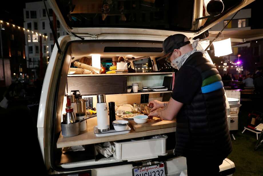 Strong prepares a private meal for three in Stella, a 1989 camper van he converted into a mobile dining room in San Francisco. Photo: Scott Strazzante / The Chronicle
