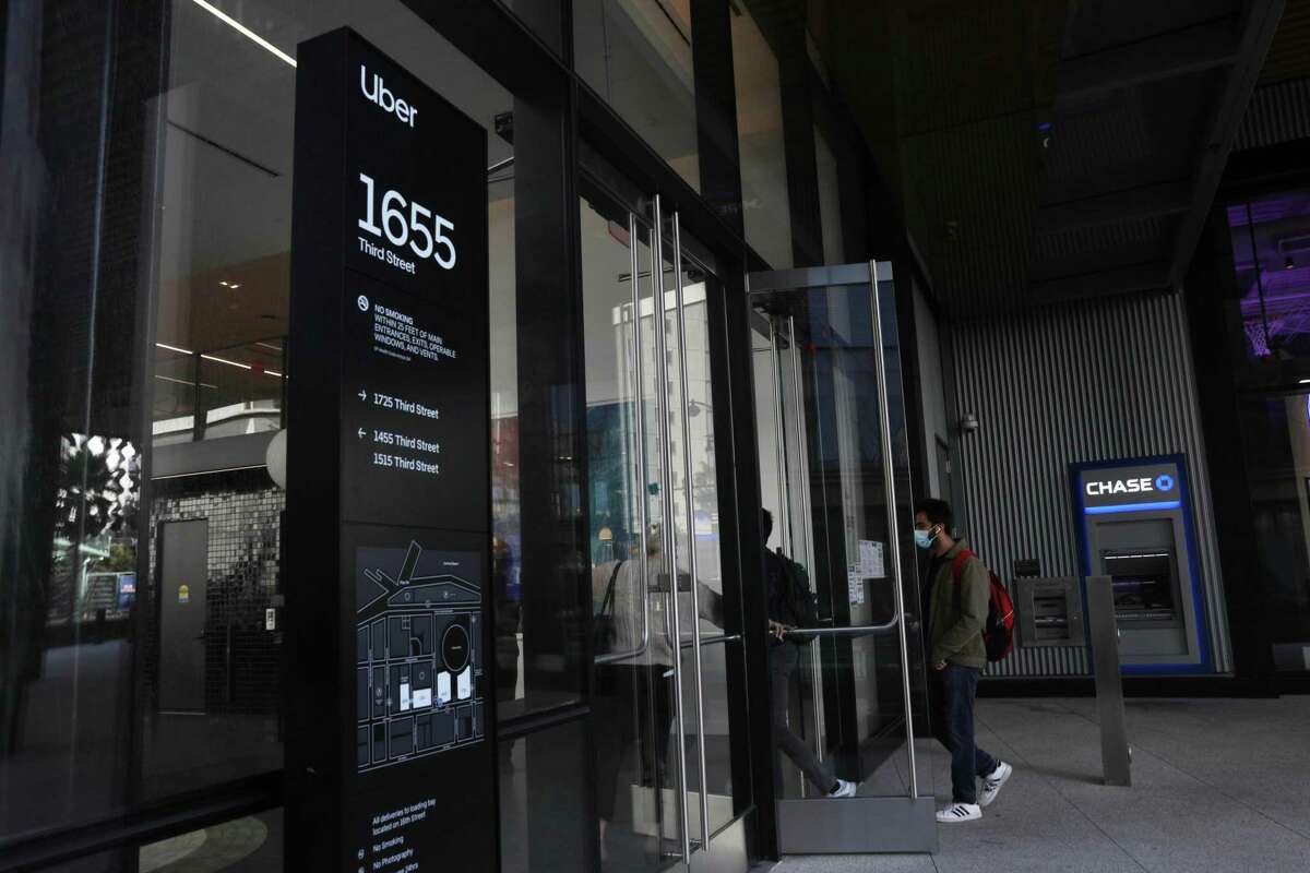 People are seen entering the Uber building at 1655 Third Street on Monday, March 29, 2021 in San Francisco, Calif.