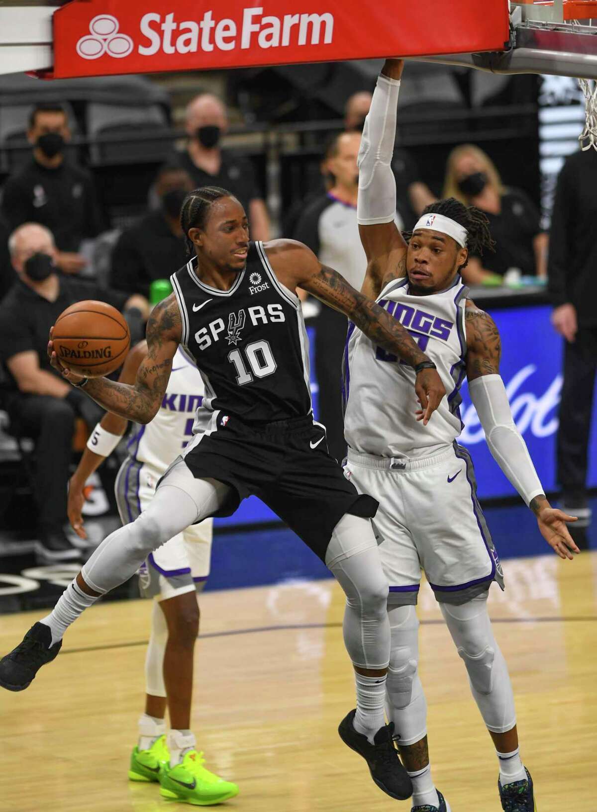 DeMar DeRozan of the San Antonio Spurs dishes off an assist to teammate Patty Mills, who made a three-point shot against the Sacramento Kings during first-half NBA action in the AT&T Center on Wednesday, March 31, 2021.