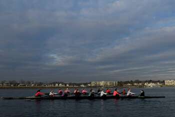 Racing each other on the water, the varsity crew team takes on the underclassmen as the two teams battle it out on the Norwalk River recently. Norwalk Harbor is in the background. "Rowing is a sport you can kind of pick up at any age, which is unique," says Jennifer Wendry, the head women's rowing coach at UConn. "Whereas with soccer, you start that at 3 or else you're not going to make it."
