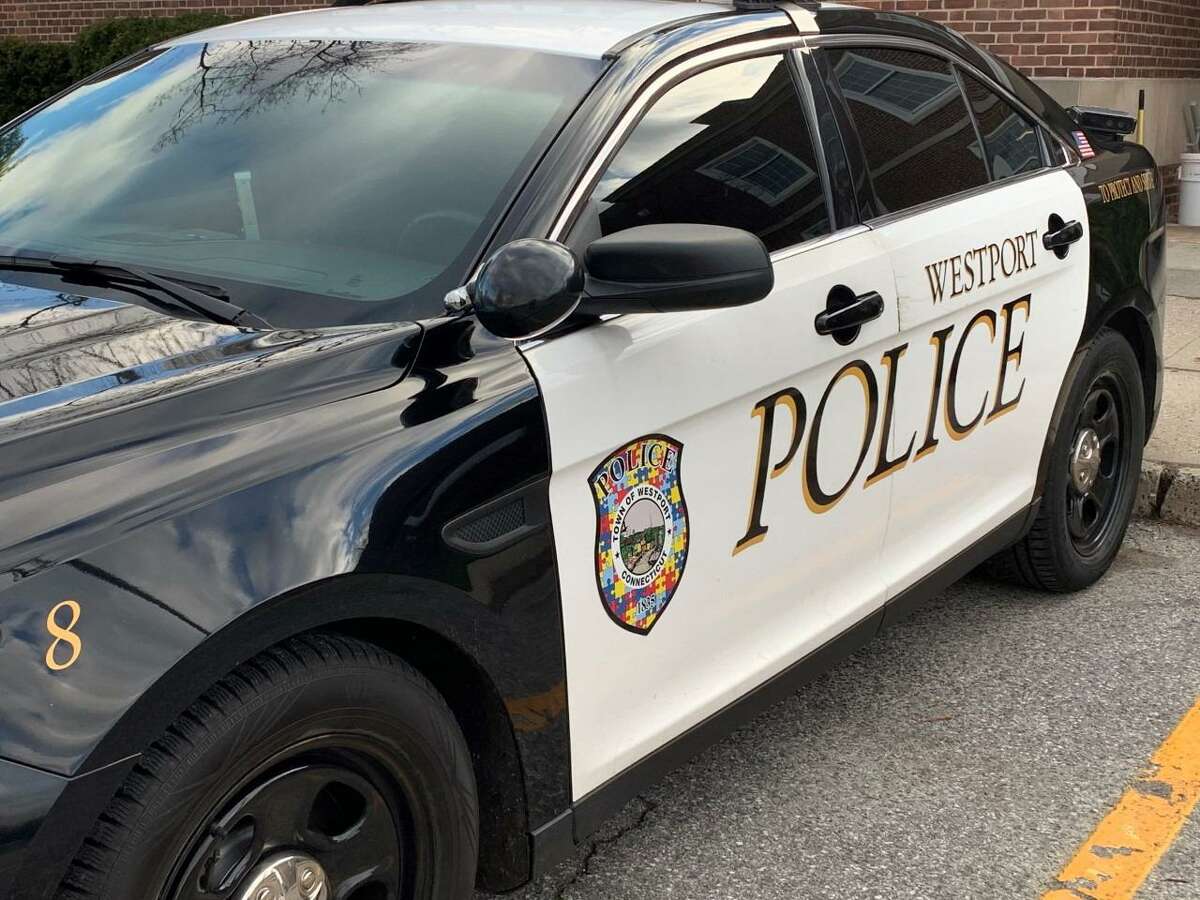 A Westport Police Department patrol car has an Autism Awareness Door with an Autism puzzle piece logo, for Autism Awareness Month, which is the month of April.