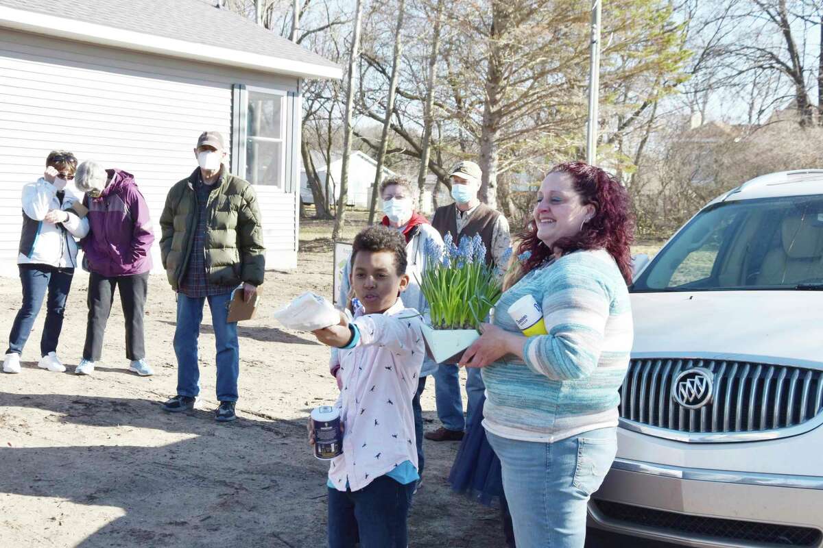 Crystal Buck's new home stands presented with a Habitat for Humanity of Manistee County sign on the lawn just prior to a dedication ceremony in March in Eastlake. Consumers Energy will donate $1 for every $2 raised up to $100,000 to Habitat for Humanity as part of its annual Power of Home campaign. (File Photo)