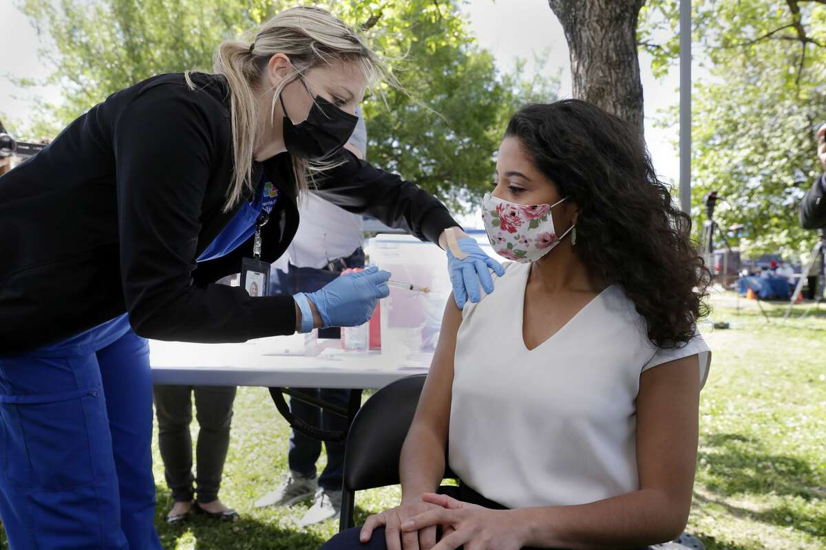 Harris Co. Judge Lina Hidalgo, right, receives her first dose of the Moderna vaccine from Haley Cox, with Harris Co. Public Health Dept., at Pitner Pocket Park Thursday, Apr. 1, 2021 in Houston, TX.