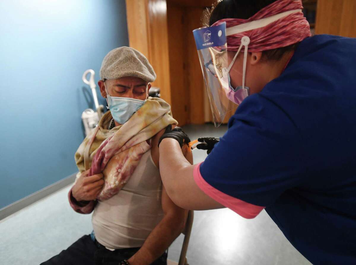 David Arroyo, of New Haven, gets his Johnson & Johnson Covid-19 vaccine during the vaccination clinic at Chapel on the Green in New Haven, Conn. on Thursday, April 1, 2021.