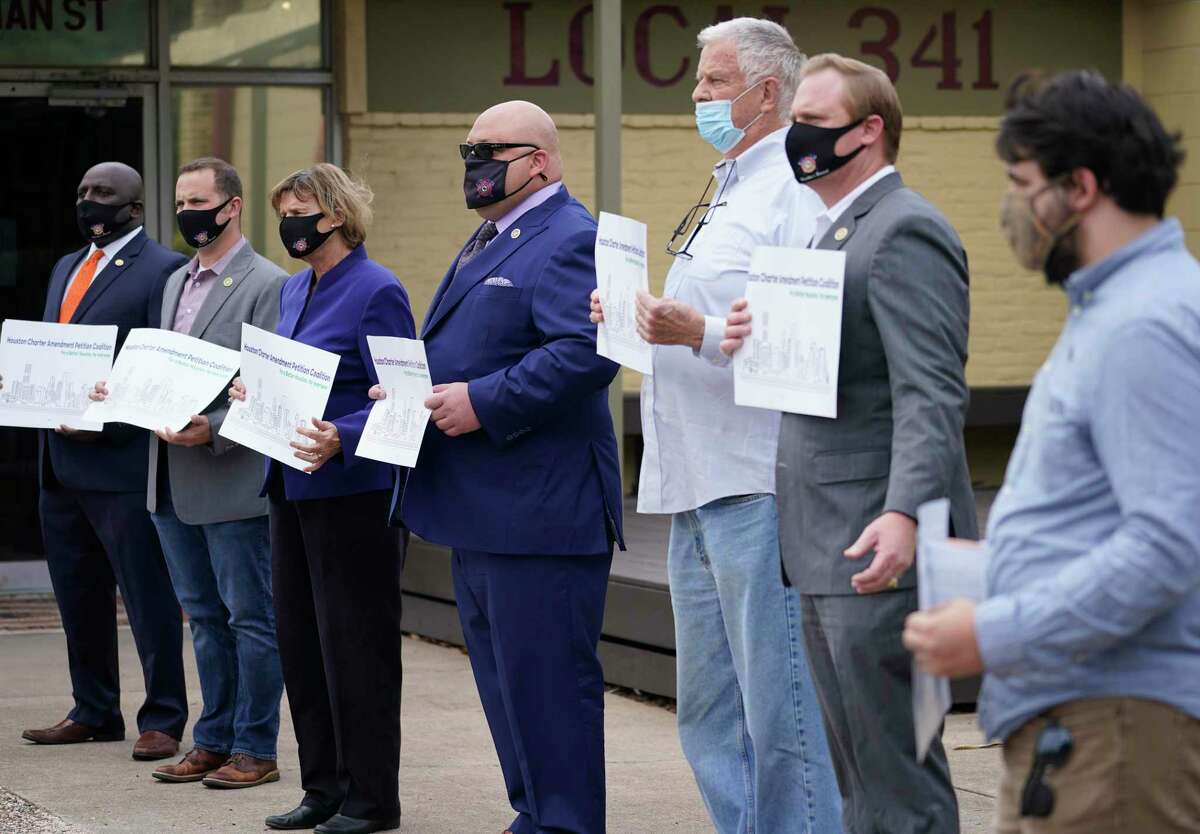 Supporters of a charter amendment to give City Council members more power to gets votes on items are shown during a media conference in October. The coalition announced it gathered the required number of signatures Thursday to get the item on the ballot.