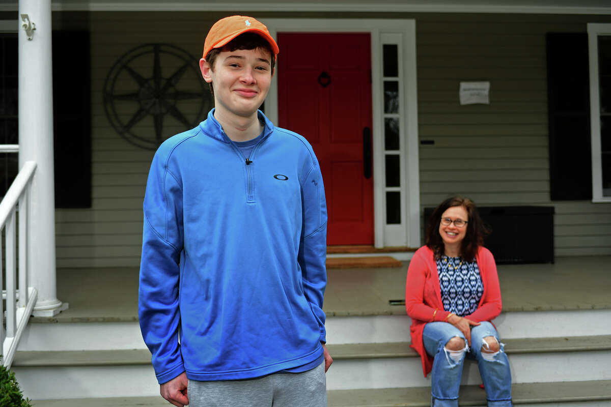 16-year-old, Luke Schwartz, and his mom, Deborah List at their home Thursday, April 1, 2021, in Wilton, Conn. Schwartz has a rare type of thyroid cancer and a host of other health issues and had hoped that, due to his health issues, he'd get the COVID vaccine early. But, when Lamont went by an age classification, His mother took matters into her own hands and got Luke vaccinated in Vermont, where the family also owns a home.