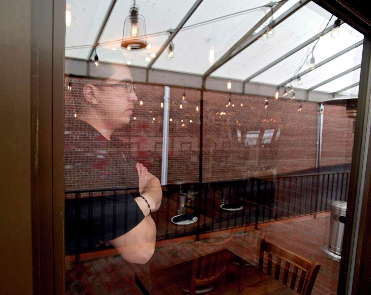 Vinny Gonzalez owner of Tablao Wine Bar looks out the dining room window. Thursday, April 1, 2021, Ridgefield, Conn.