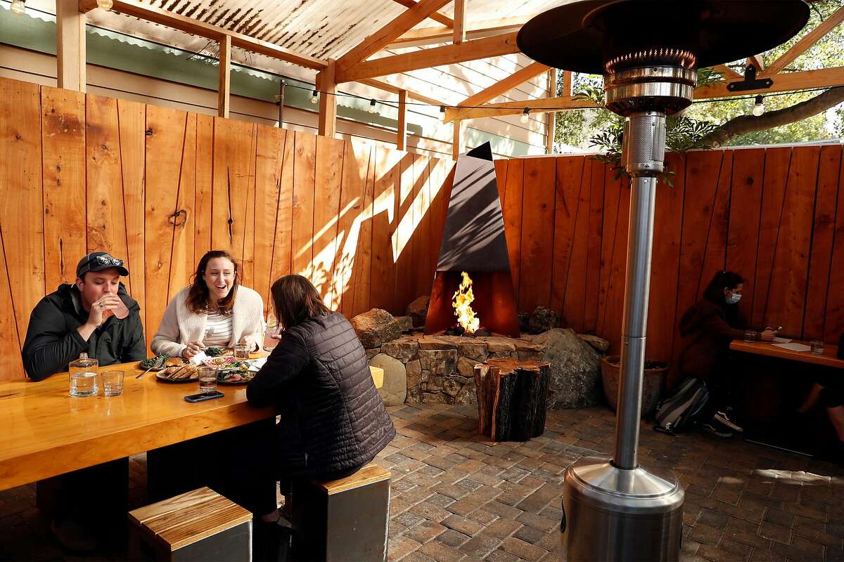 The back patio, heated with lamps and a fireplace, at Stillwater in Fairfax.