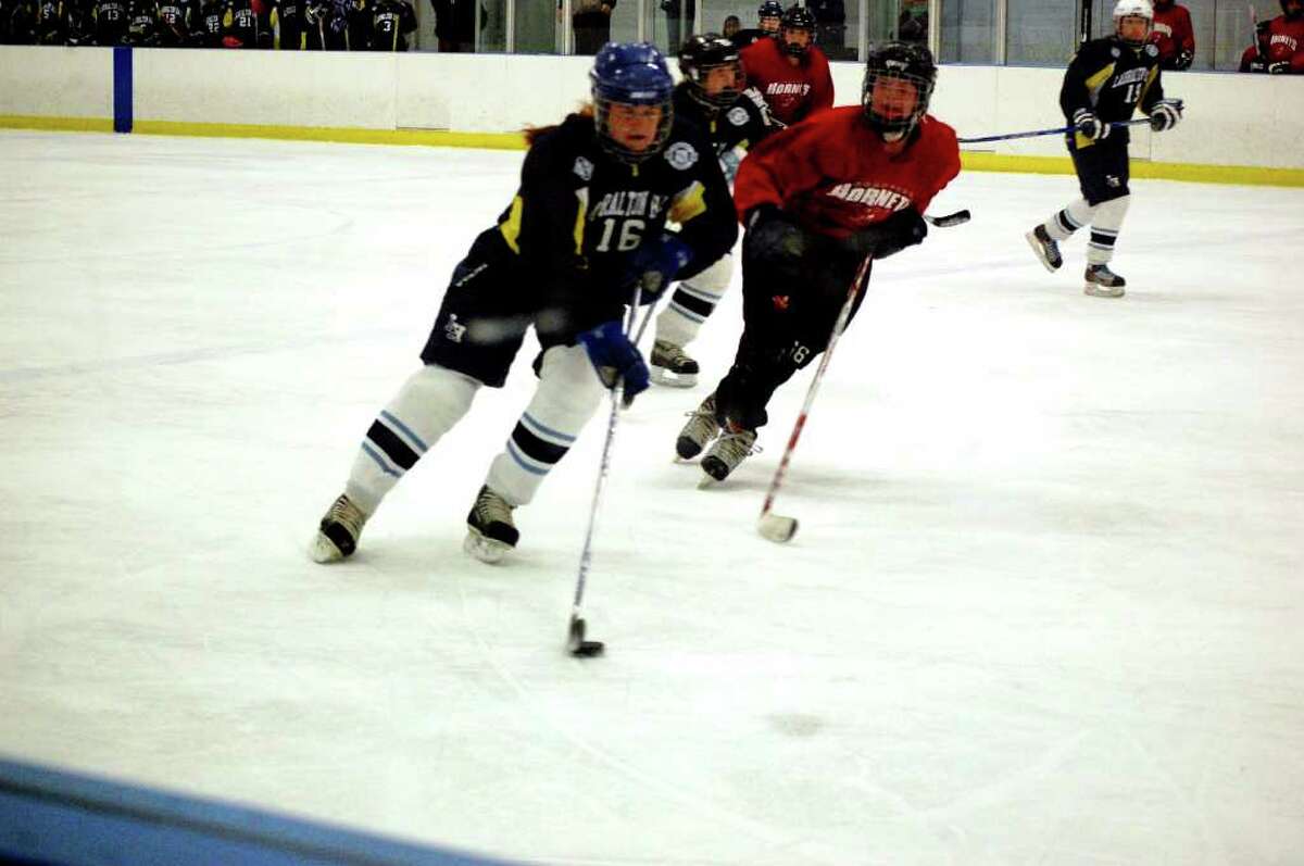 Suzanne Fitzpatrick, a member of the Lauralton Hall hockey team, moves the puck down the ice in a recent game.