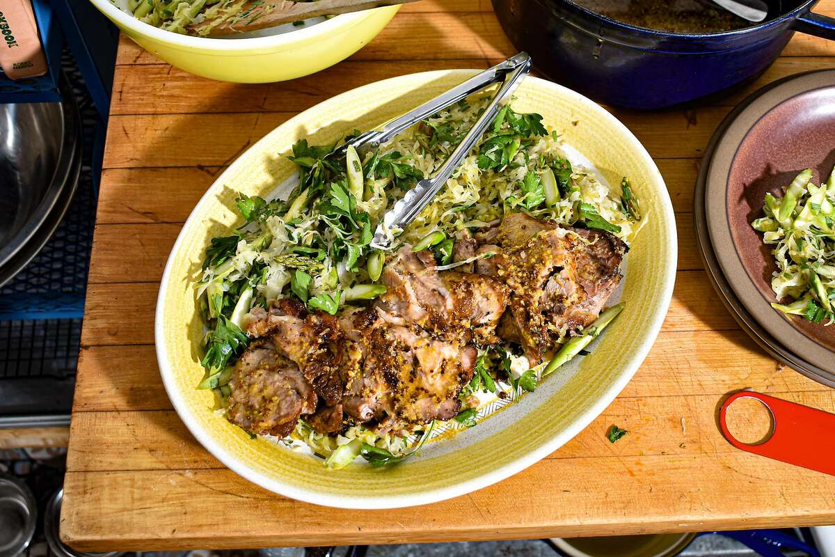 This herbaceous pork shoulder uses lots of fresh chopped herbs to brighten the salty sauerkraut.
