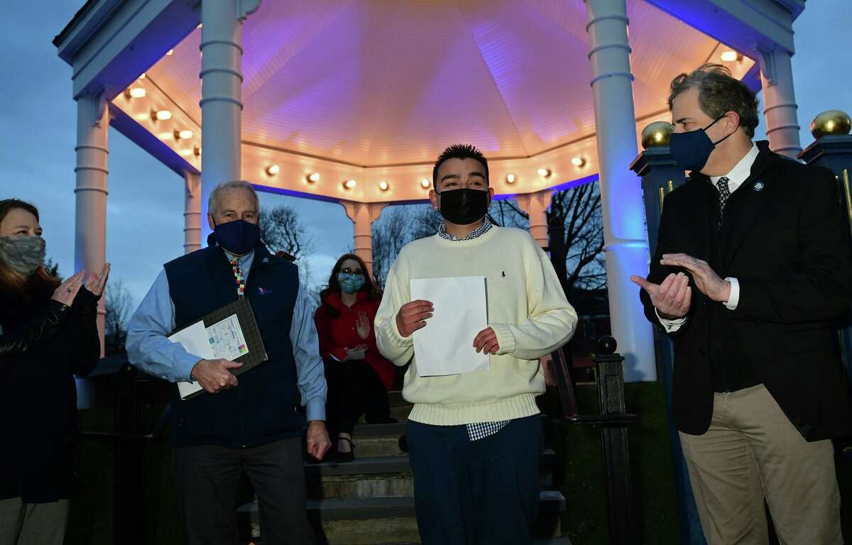 Norwalk Next Steps program participant Alan Guerrero, 19, speaks during the annual "Light It Up Blue" ceremony in honor of the beginning of autism awareness month Thursday, April 1, 2021, at the town green in Norwalk, Conn.