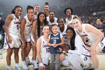 Daniela Ciriello is pictured with the 2019-20 UConn women's basketball team. Ciriello, who suffers from a genetic blood disorder, was named a member of the team two years ago and keeps in close contact with the team. This week she was surprised with a trip to the Final Four.
