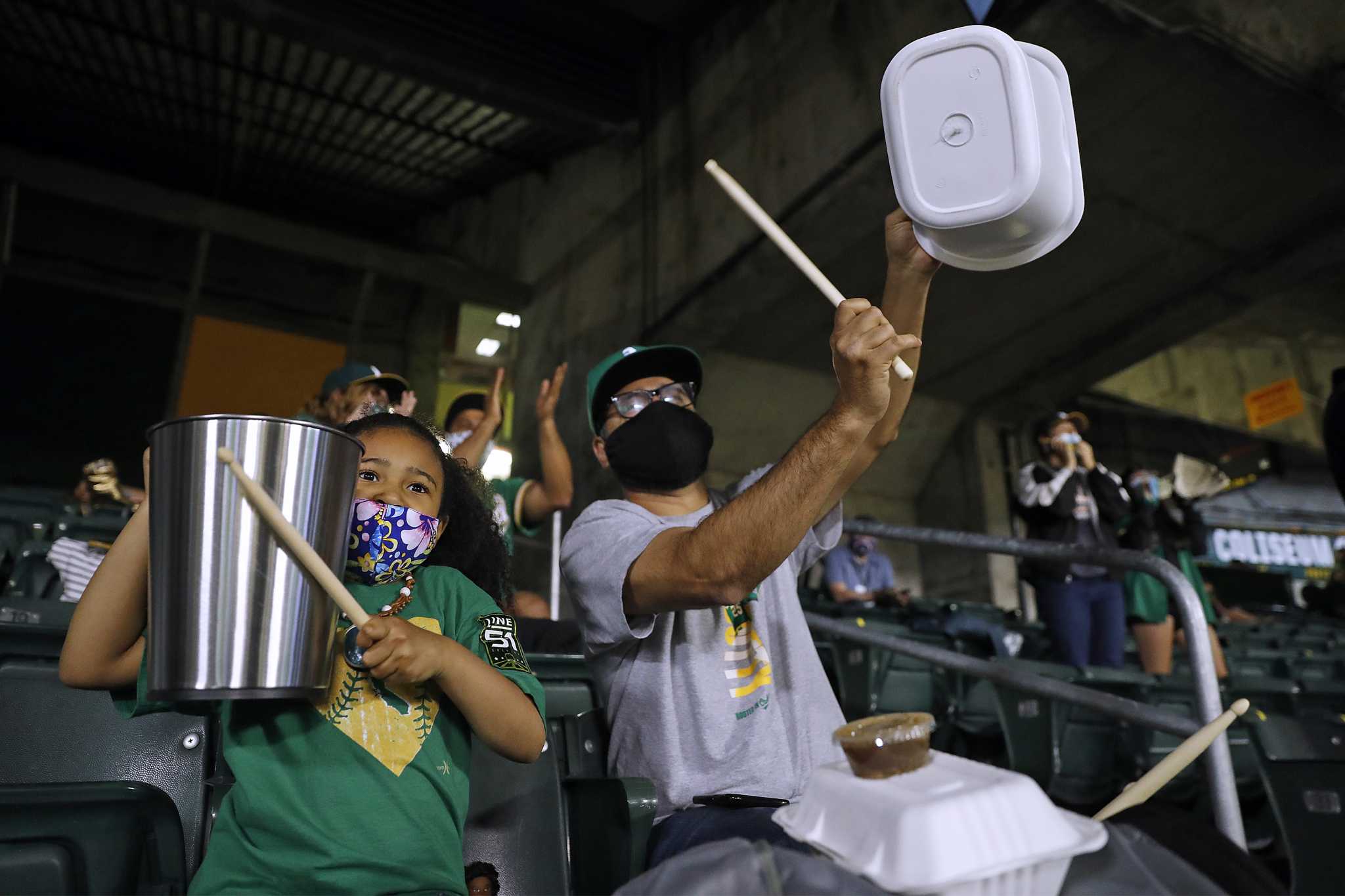 Oakland, United States. 04th Apr, 2021. Oakland A's fans greet each other  in the stands before the A's take on the Houston Astros at the Oakland  Coliseum in Oakland, California on Saturday