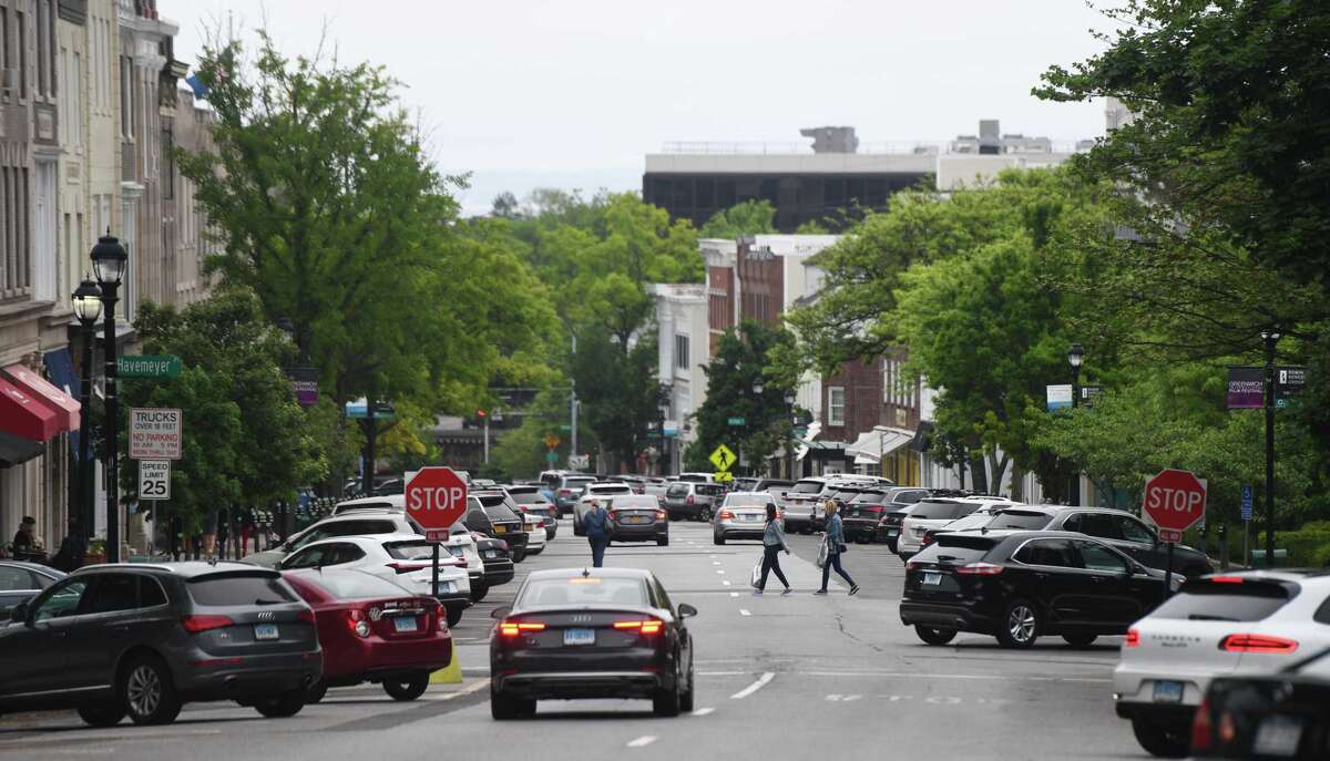 Pedestrians cross the Greenwich Avenue at its intersection with Arch Street last year in Greenwich.