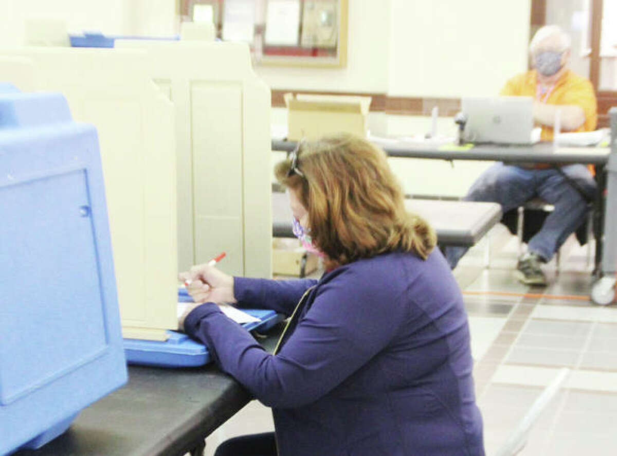 Debby Niebur, of Edwardsville, casts her ballot during early voting at the Madison County Administration Building in last year's spring municipal election. Because of changes in state law, this year's primary election was set back to late June.