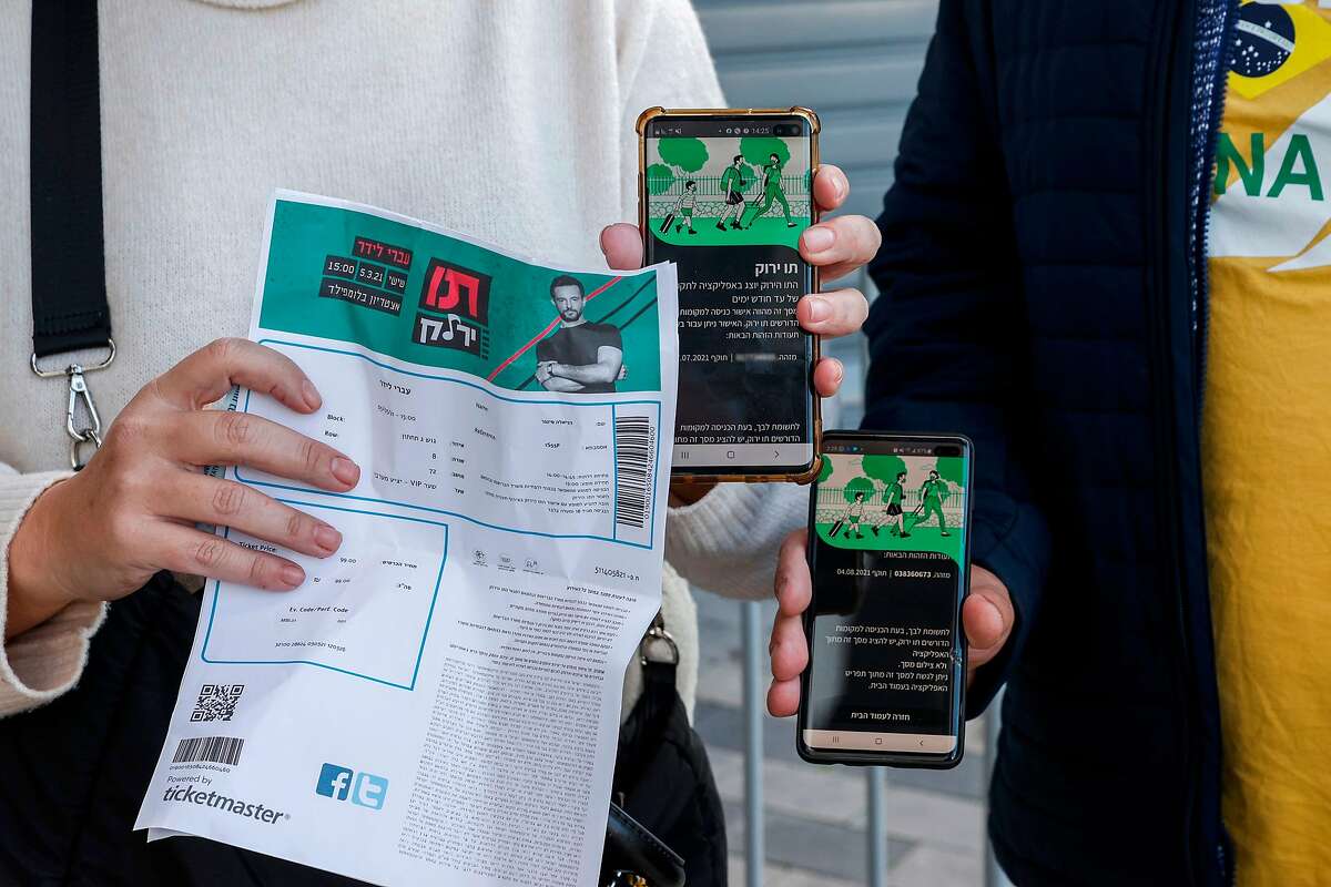 Attendees show off their proof of being fully vaccinated as they arrive at Bloomfield Stadium in Tel Aviv last month.