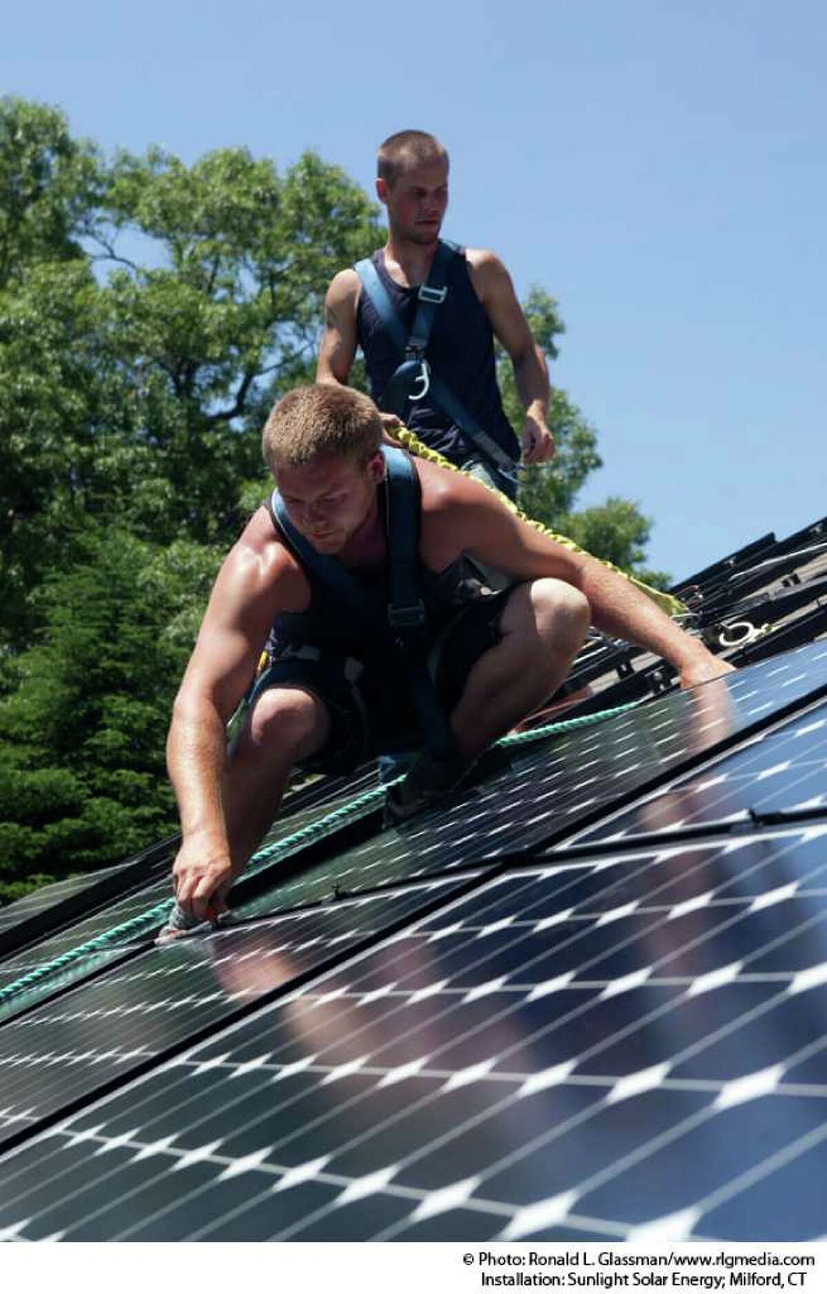 Kevin Hastings and Joey Barrios of Sunlight Solar Energy install solar panels. The Milford-based company is one of more than 100 exhibitors that will be on hand at Live Green CT!