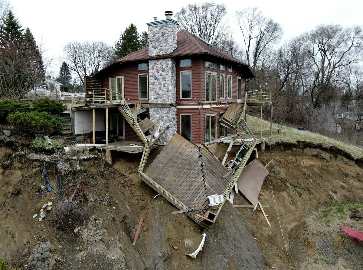 The Murphy property on Weaver Avenue still teeters on the edge of an embankment following a landslide last year on Friday, April 2, 2021, in Waterford, N.Y. (Will Waldron/Times Union)