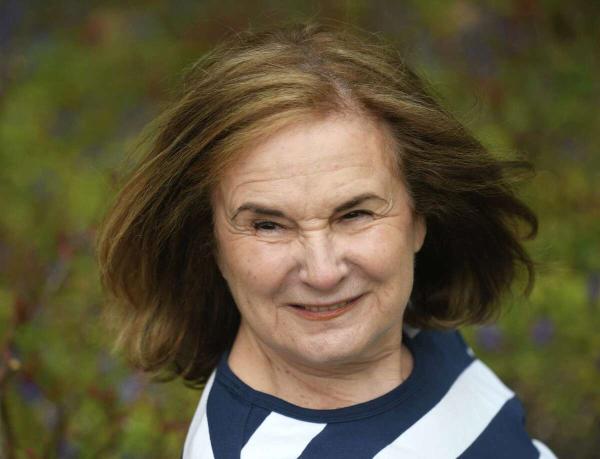 Judy Bring, 77, poses outside her home in Greenwich, Conn. Thursday, April 1, 2021. Bring has been very cautious about COVID from the start and has only seen her grandchildren and children in Boston once in the last year.