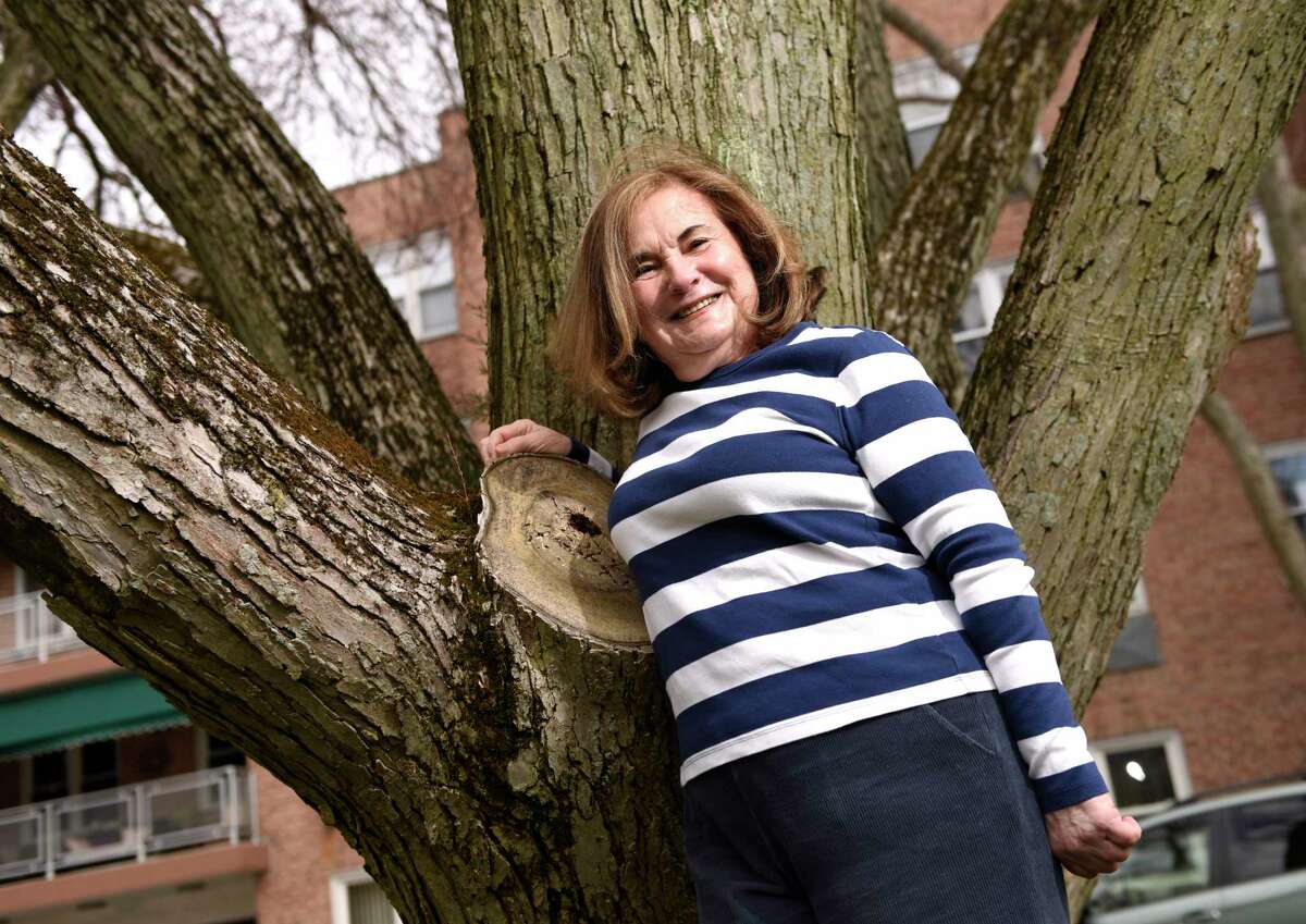 Judy Bring, 77, poses outside her home in Greenwich, Conn. Thursday, April 1, 2021. Bring has been very cautious about COVID from the start and has only seen her grandchildren and children in Boston once in the last year.