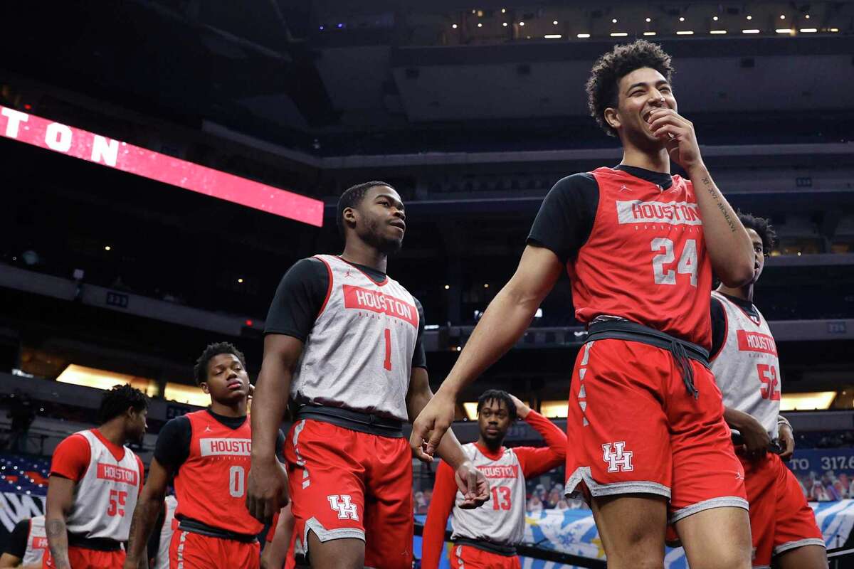 Quentin Grimes (24) and Jamal Shead (1) of the Houston Cougars take the court with their teammates for practice ahead of the Final Four Semifinal at Lucas Oil Stadium in Indianapolis.