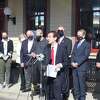 State Sen. Will Haskell, front, speaks at a recent rally at the Westport Train Station with fellow electric vehicle supporters behind him.