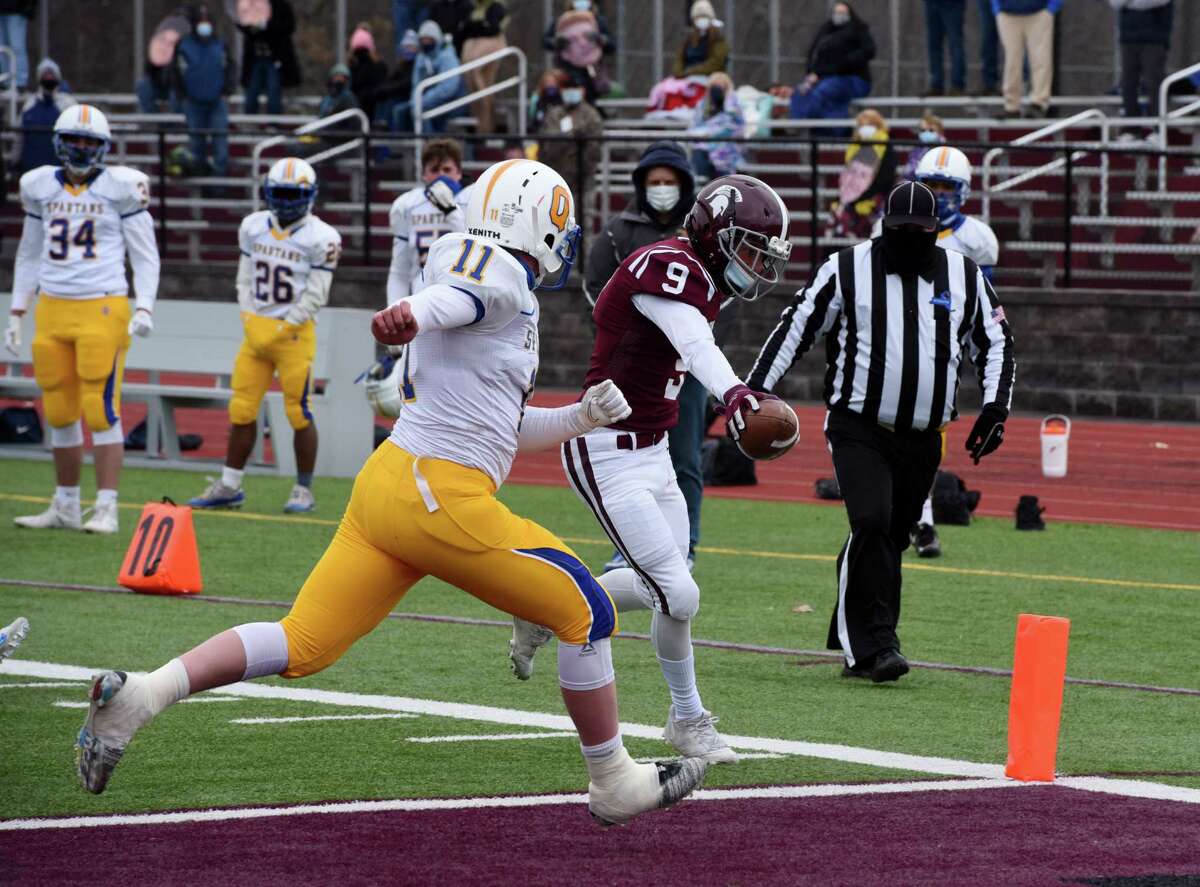 Burnt Hills-Ballston Lake wide receiver Rocco Mareno, right, tips the ball over the line to score a touchdown against Queensbury High School during a varsity football game on Friday, April 2, 2021, at Burnt Hills-Ballston Lake High School in Ballston, N.Y. (Will Waldron/Times Union)