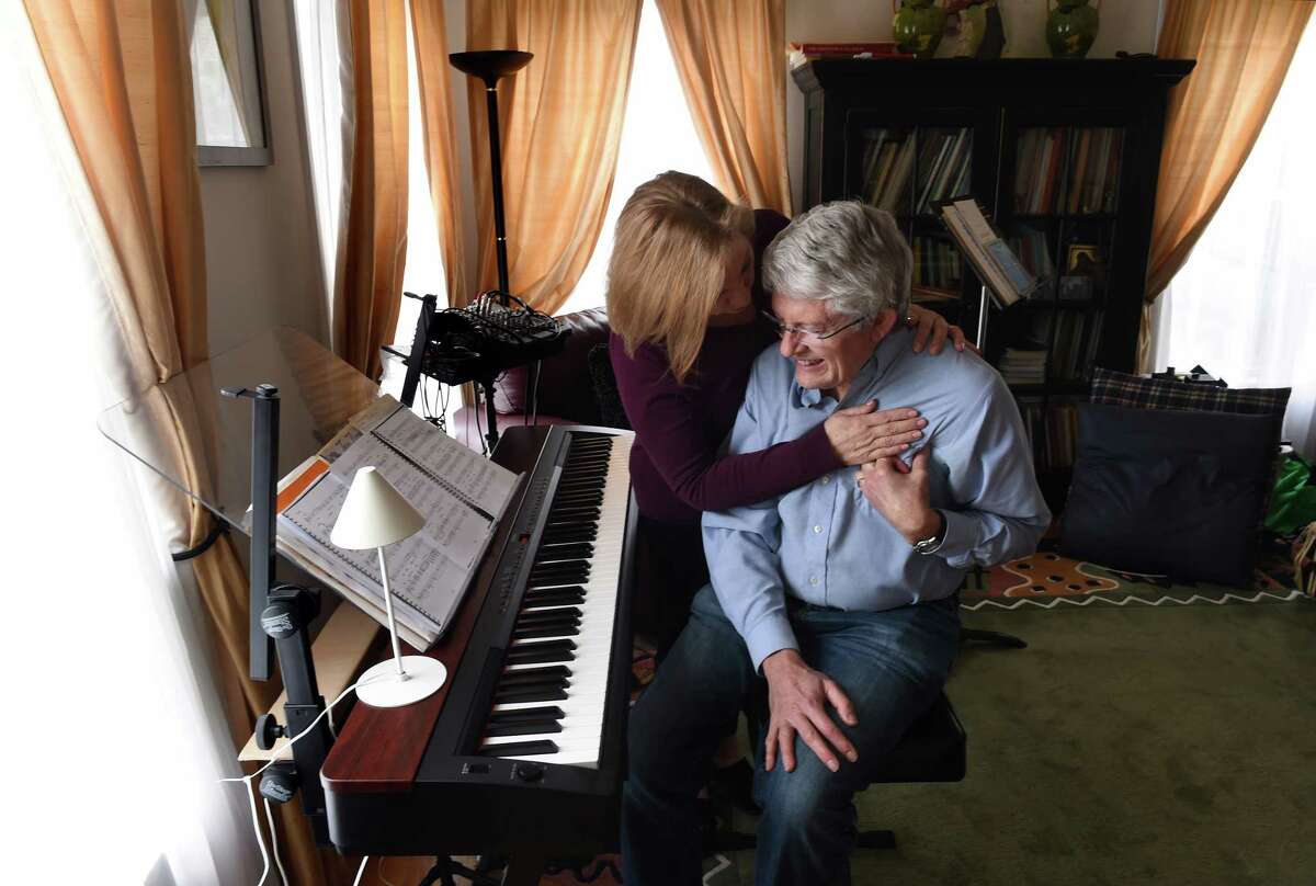 Evelyn Gard holds her husband, Richard, as he experiences cardiac pain due to the lingering effects of COVID-19 at their home in Beacon Falls on April 2, 2021. Richard Gard hospitalized at Yale New Haven Hospital in March of 2020 for COVID-19.