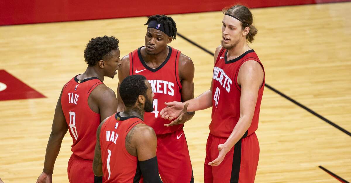 Houston Rockets forward Jae'Sean Tate (8), Houston Rockets guard John Wall (1), Houston Rockets forward Danuel House Jr. (4) and Houston Rockets forward Kelly Olynyk (41) walk back to a timeout during the second quarter of an NBA game between the Houston Rockets and the Memphis Grizzlies on Monday, March 29, 2021, at Toyota Center in Houston.