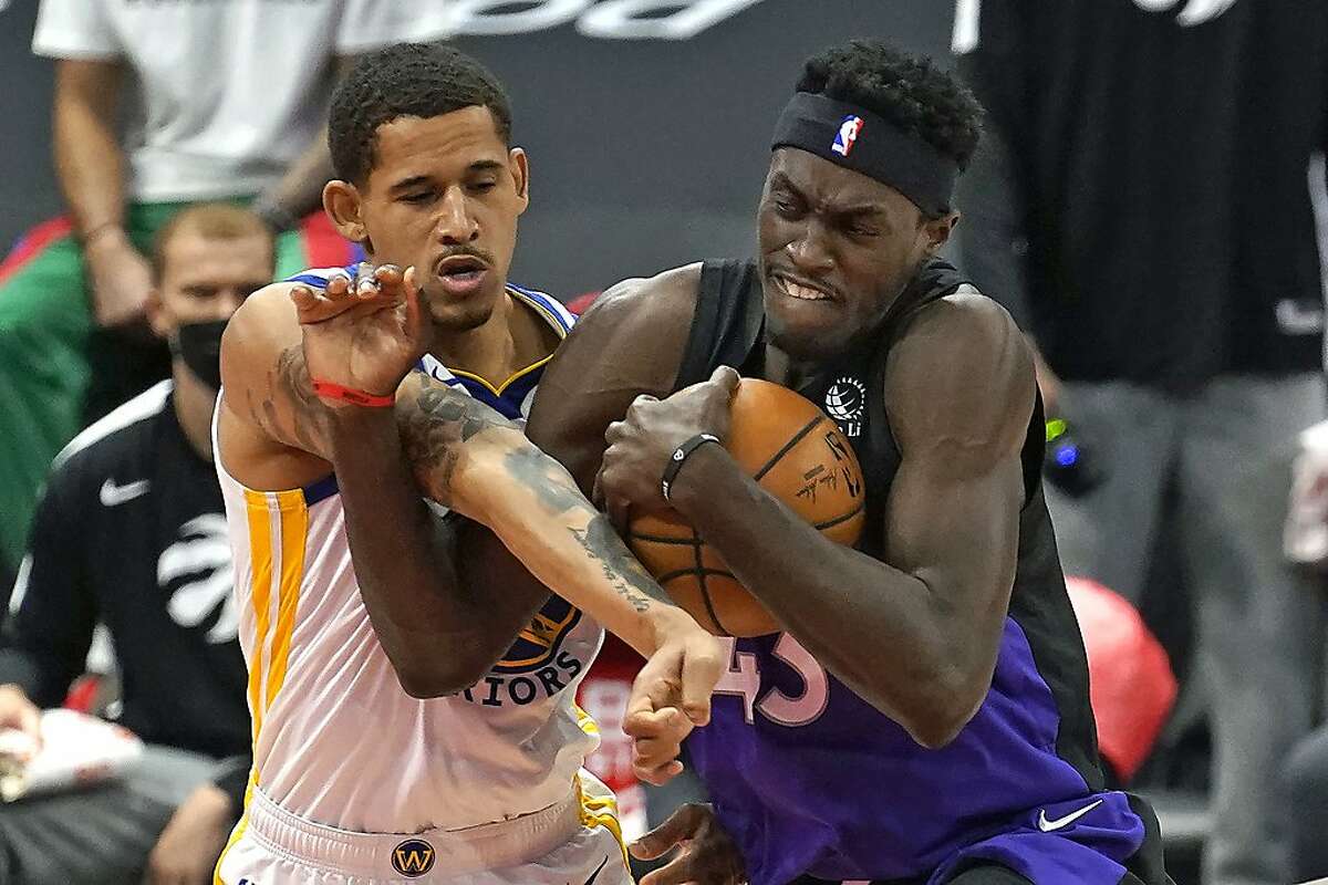 Toronto Raptors forward Pascal Siakam (43) and Golden State Warriors forward Juan Toscano-Anderson (95) get tangled up during the first half of an NBA basketball game Friday, April 2, 2021, in Tampa, Fla. (AP Photo/Chris O'Meara)