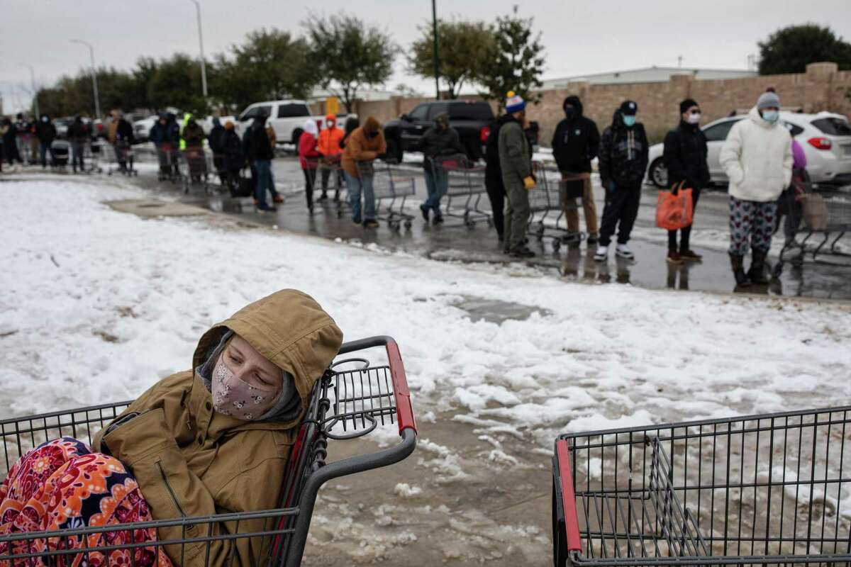 Camilla Swindle, 19, sits in a shopping cart as she and her boyfriend wait in a long line to enter a grocery store in Austin, Texas on Tuesday, Feb. 16, 2021, as people stock up ahead of another expected storm. Huge winter storms have plunged large parts of the central and southern United States into an energy crisis this week as frigid blasts of Arctic weather crippled electric grids and left millions of Americans without power amid dangerously cold temperatures. (Tamir Kalifa/The New York Times)