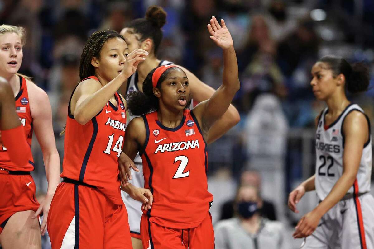 SAN ANTONIO, TEXAS - APRIL 02: Sam Thomas #14 of the Arizona Wildcats and Aari McDonald #2 signal toward the bench against the UConn Huskies during the second quarter in the Final Four semifinal game of the 2021 NCAA Women's Basketball Tournament at the Alamodome on April 02, 2021 in San Antonio, Texas. (Photo by Elsa/Getty Images)