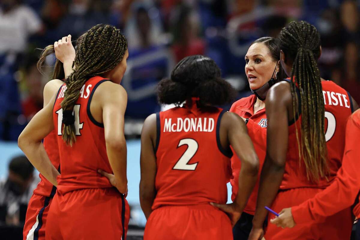 SAN ANTONIO, TEXAS - APRIL 02: Head coach Adia Barnes of the Arizona Wildcats speaks with players in the huddle against the UConn Huskies in the Final Four semifinal game of the 2021 NCAA Women's Basketball Tournament at the Alamodome on April 02, 2021 in San Antonio, Texas. (Photo by Elsa/Getty Images)