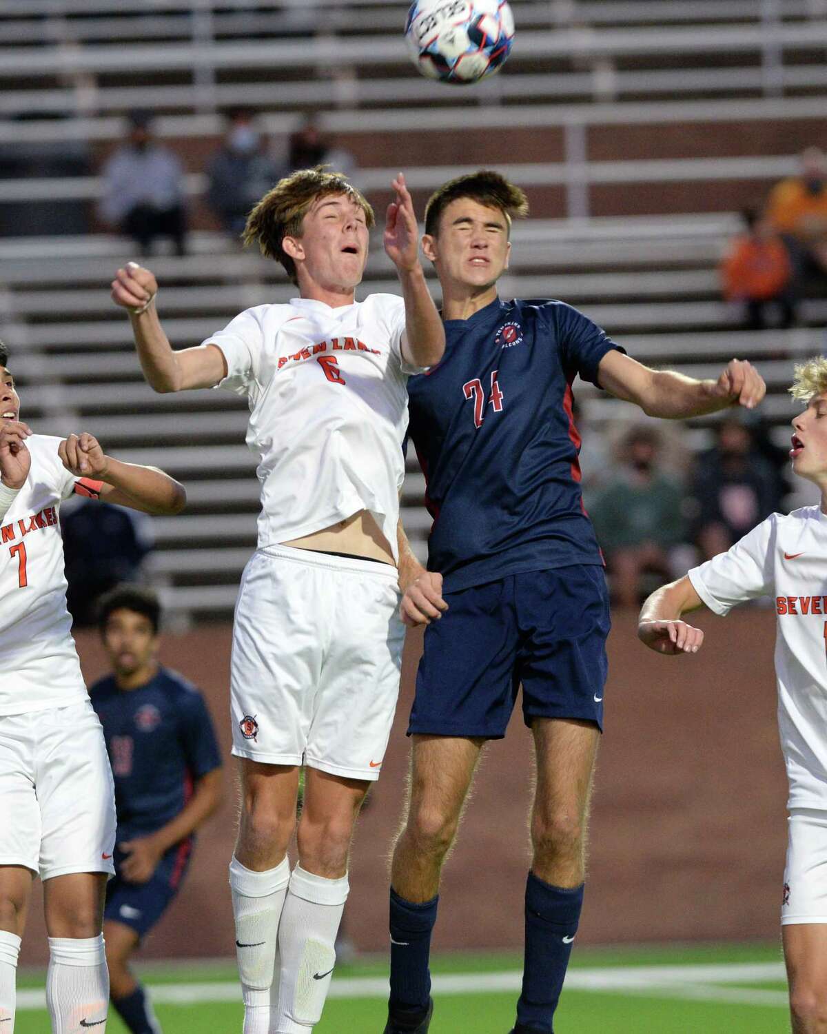 Aidan Morrison (6) of Seven Lakes and Ian Aumagher (24) of Tompkins head a ball during the first half of a 6A-III regional quarterfinal soccer match between the Seven Lakes Spartans and the Tompkins Falcons on Friday, April 2, 2021 at Legacy Stadium, Katy, TX.