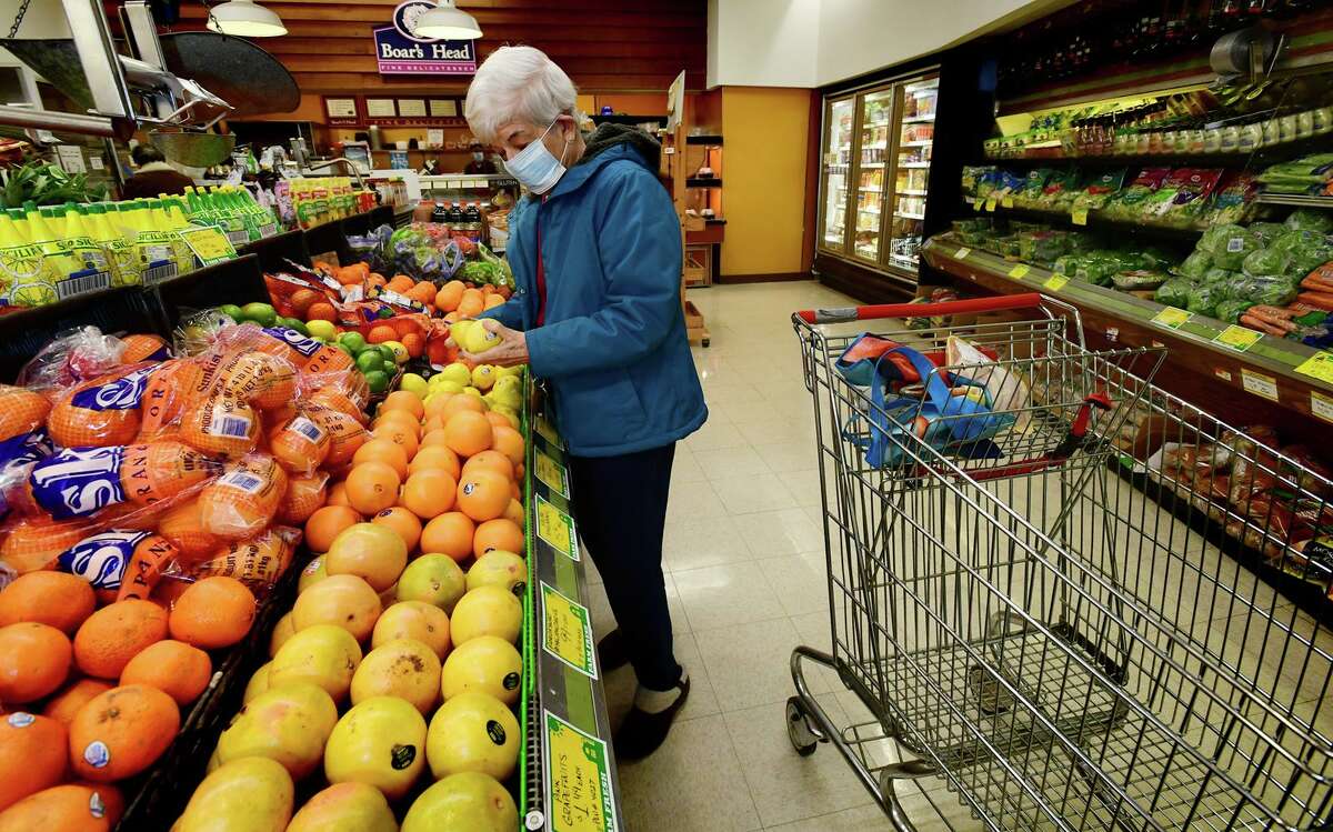 Customers including Ann Rully shop at Cranbury Market Friday, April 2, 2021, in the Cranbury neighborhood in Norwalk, Conn.