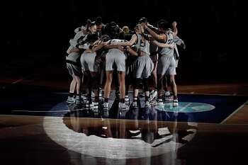 Connecticut players huddle before a women's Final Four NCAA college basketball tournament semifinal game against the Arizona Friday, April 2, 2021, at the Alamodome in San Antonio. (AP Photo/Morry Gash)
