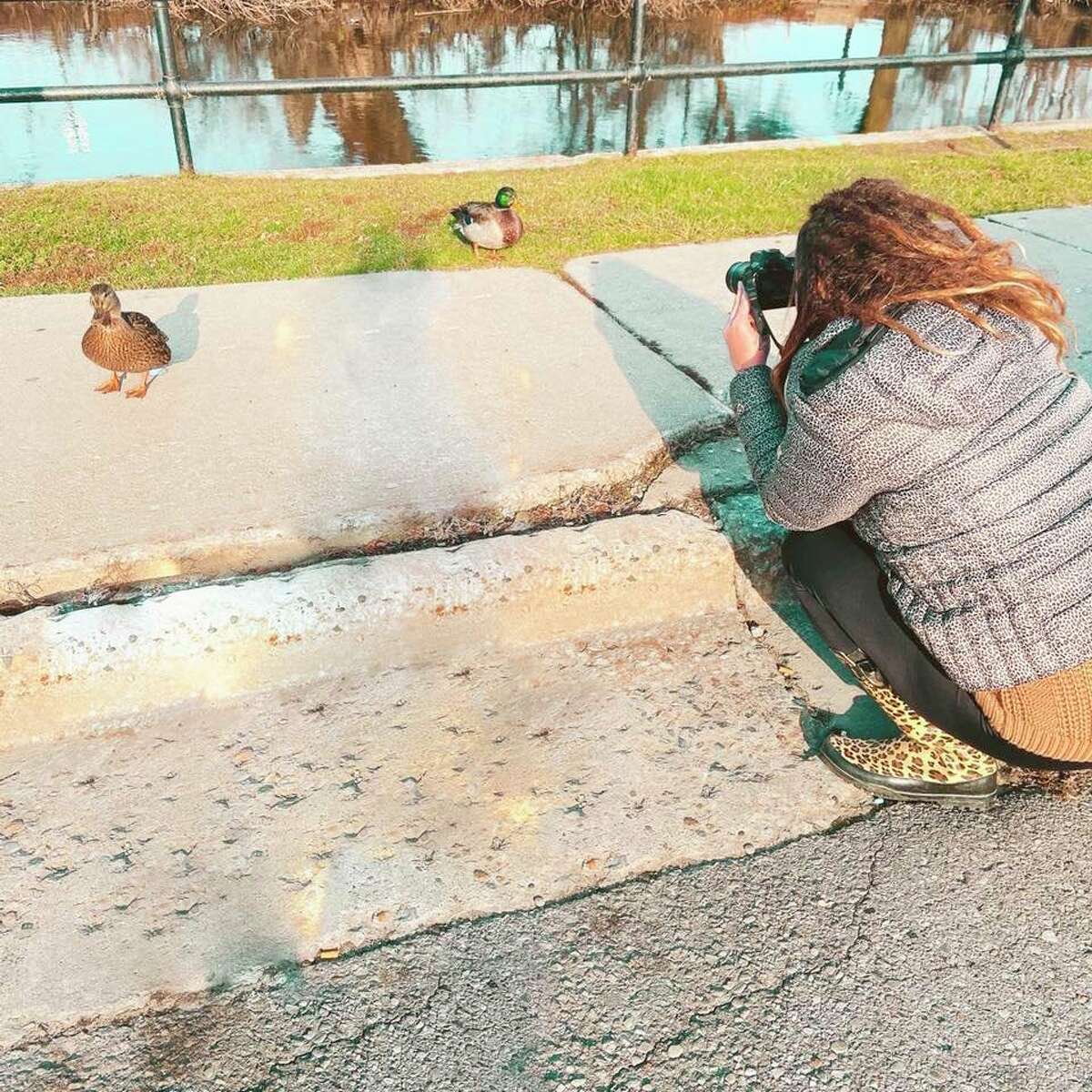 Vaughn is pictured taking a picture of a duck. As well as animals, she enjoys photographing families, nature scenes and more. (Courtesy photo)