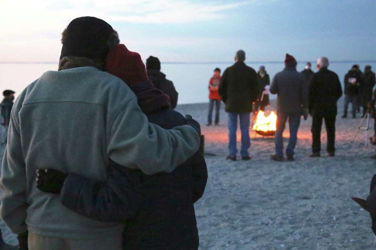 A couple enjoys a moment together at the Easter Sunday Sunrise Service at Compo Beach on April 4, 2021.