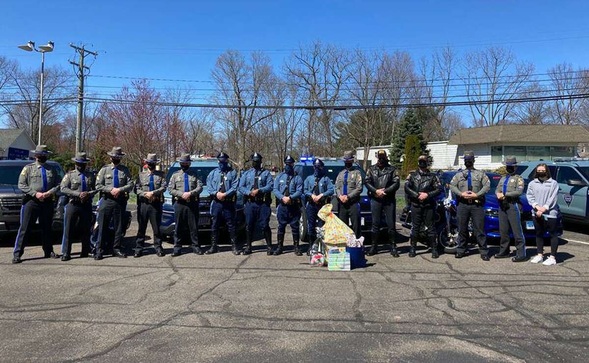 State troopers from Massachusetts and Connecticut helped deliver gifts from the New Hampshire state police to a girl living in Connecticut whose parents both died recently in New Hampshire.