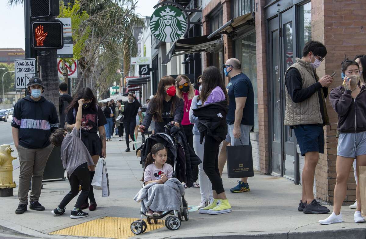 Pedestrians pack sidewalks on Colorado Blvd. in Old Town Pasadena on Sunday, Mar. 21, 2021.