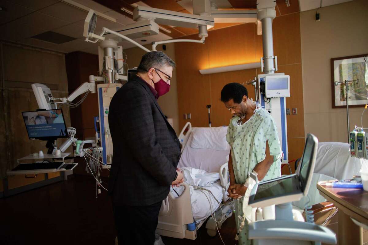Gowan prays for Kiven Leday, a 55-year-old patient waiting for a heart transplant at Houston Methodist Hospital.