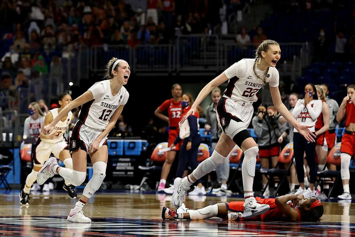 Stanford’s Cameron Brink and Lexie Hull run past Arizona’s Aari McDonald after McDonald misfired on her last-second shot, allowing the Cardinal to hold on to win 54-53 in Sunday’s national championship game.