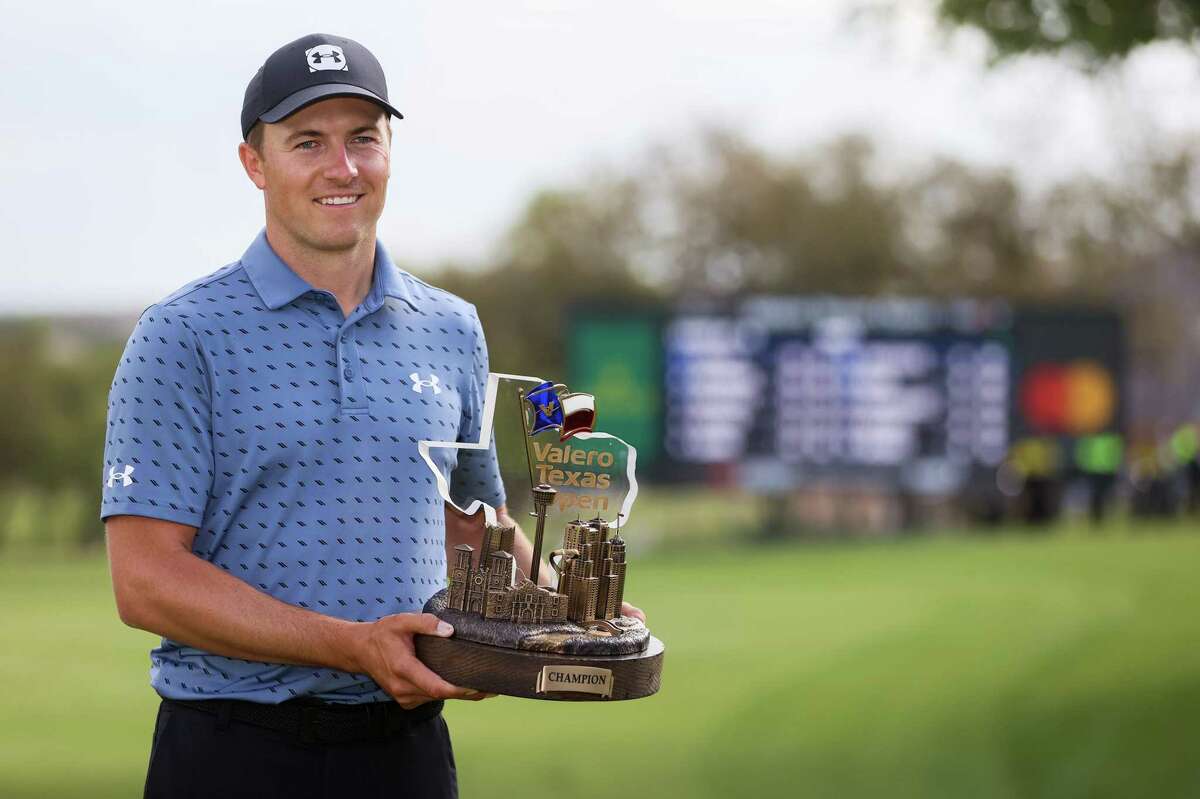 Jordan Spieth holds the championship trophy after winning the Valero Texas Open at the TPC San Antonio’s Oaks Course on Sunday, April 4, 2021. Spieth shot a 6-under 66 on Sunday to win the tournament by two strokes over Charley Hoffman.
